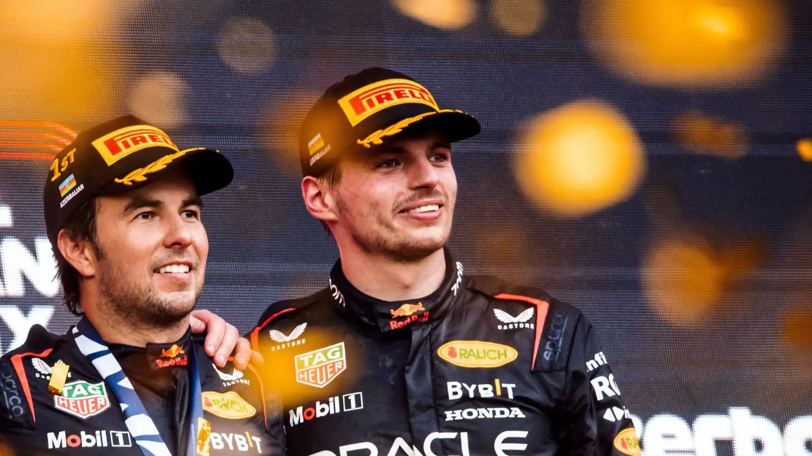Red Bull drivers Sergio Perez and Max Verstappen pose on the podium after a one-two finish in Azerbaijan. Baku, April 2023.