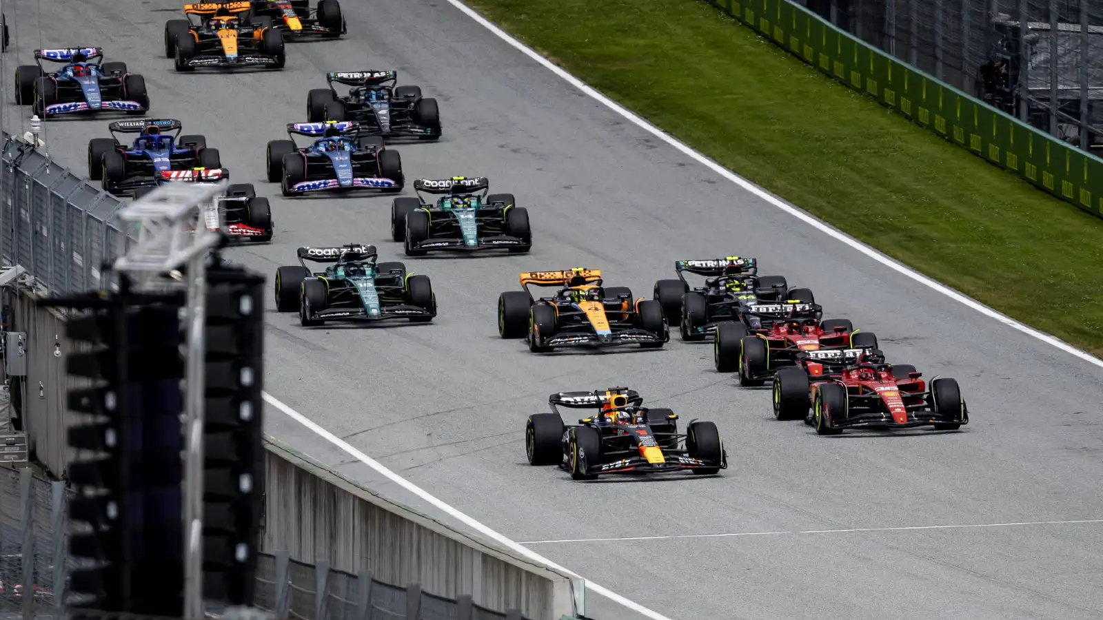 Red Bull driver Max Verstappen leads into Turn 1 at the Austrian Grand Prix. Spielberg, July 2023. Time penalties