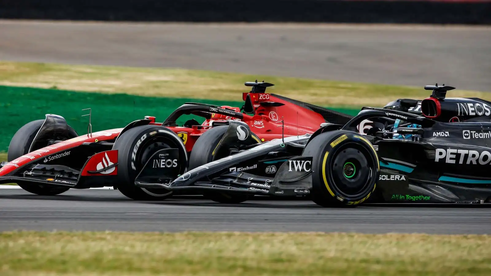 Charles Leclerc goes side-by-side with George Russell as the Mercedes driver overtakes around the outside at Luffield.