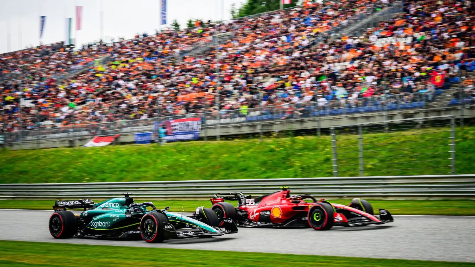 Carlos Sainz (Ferrari) passes Lance Stroll (Aston Martin) in the sprint shootout at the Austrian Grand Prix. Styria, July 2023.