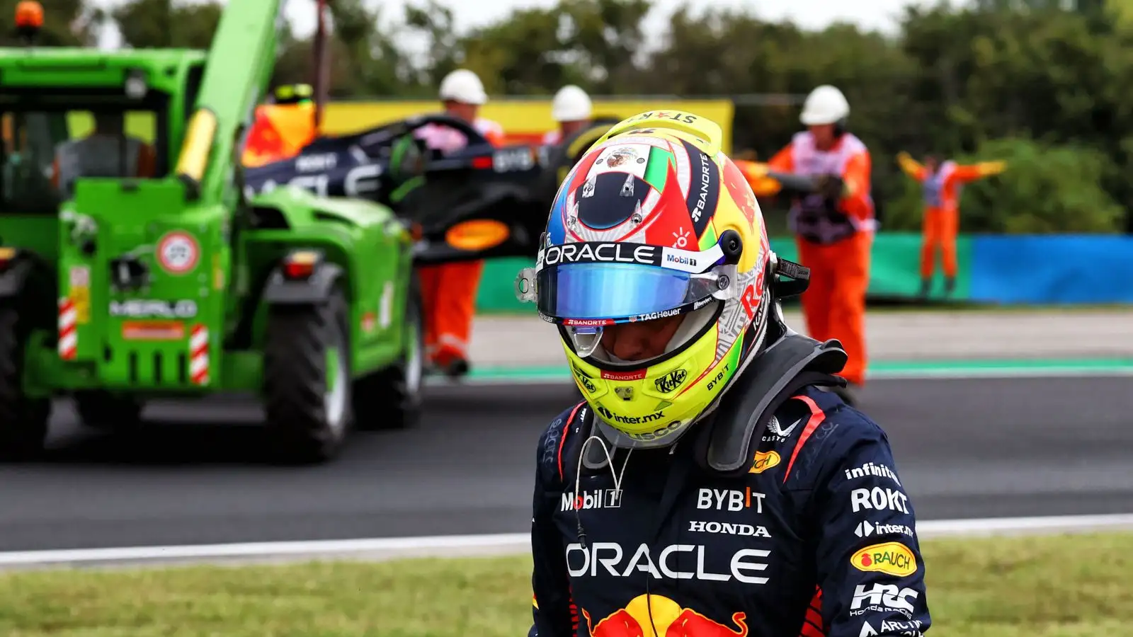 Sergio Perez walks away from his stricken Red Bull RB19 after crashing out of FP1 at the Hungarian Grand Prix. Budapest, July 2023.