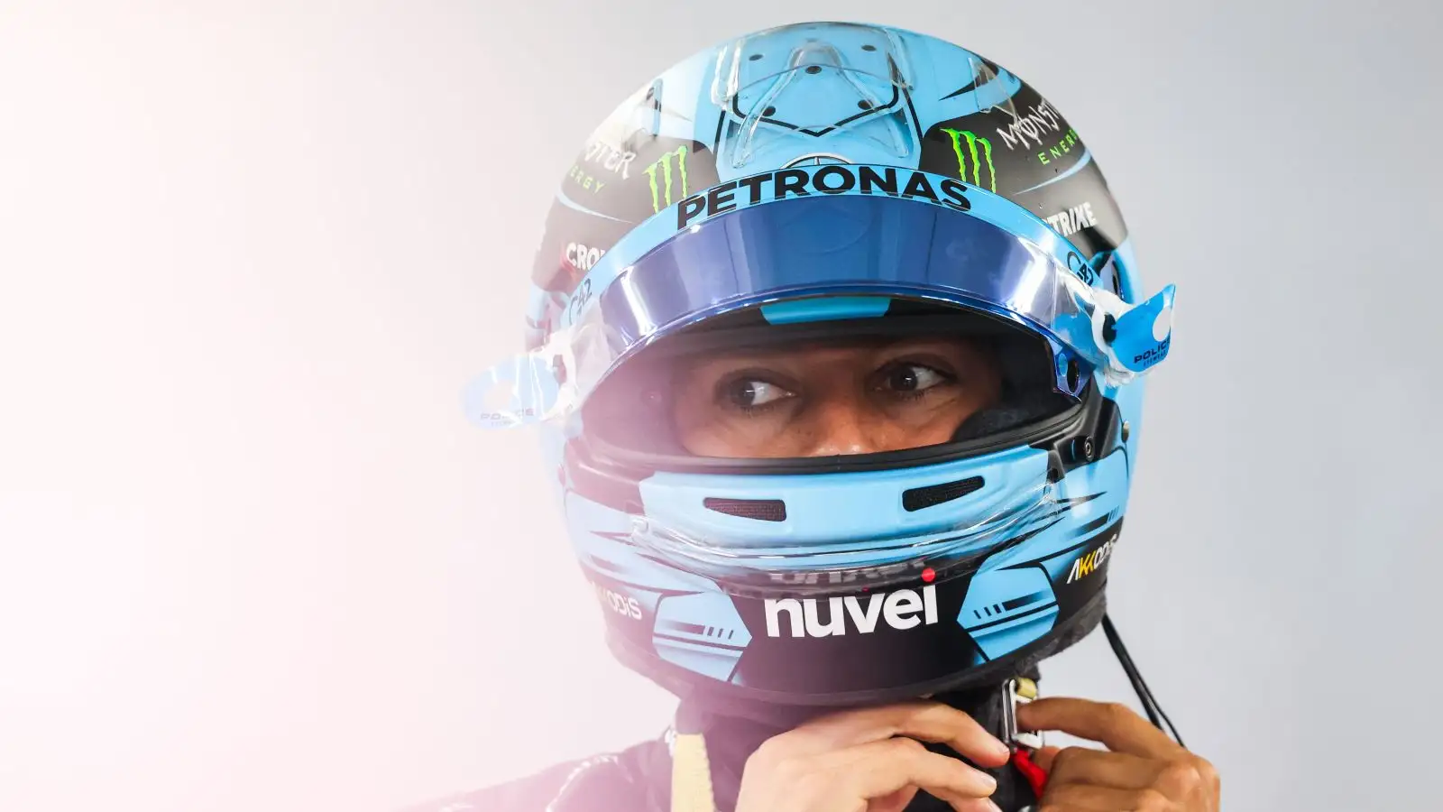 Mercedes driver George Russell dons his helmet at the Hungarian Grand Prix. Budapest, July 2023.
