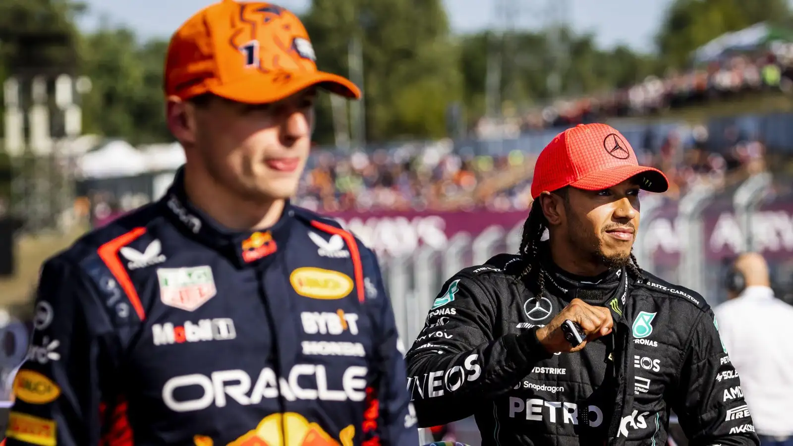 Max Verstappen walks past Lewis Hamilton. Hungary, Budapest July 2023.
