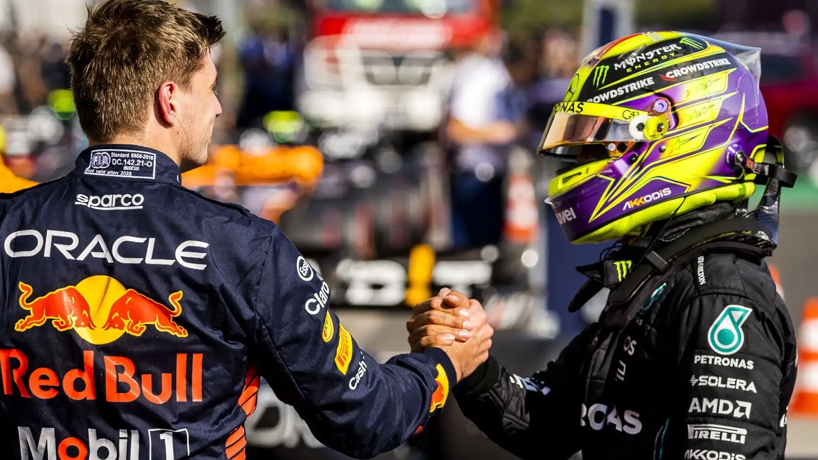 Lewis Hamilton, Mercedes, and Max Verstappen, Red Bull, shake hands. Hungary, July 2023.