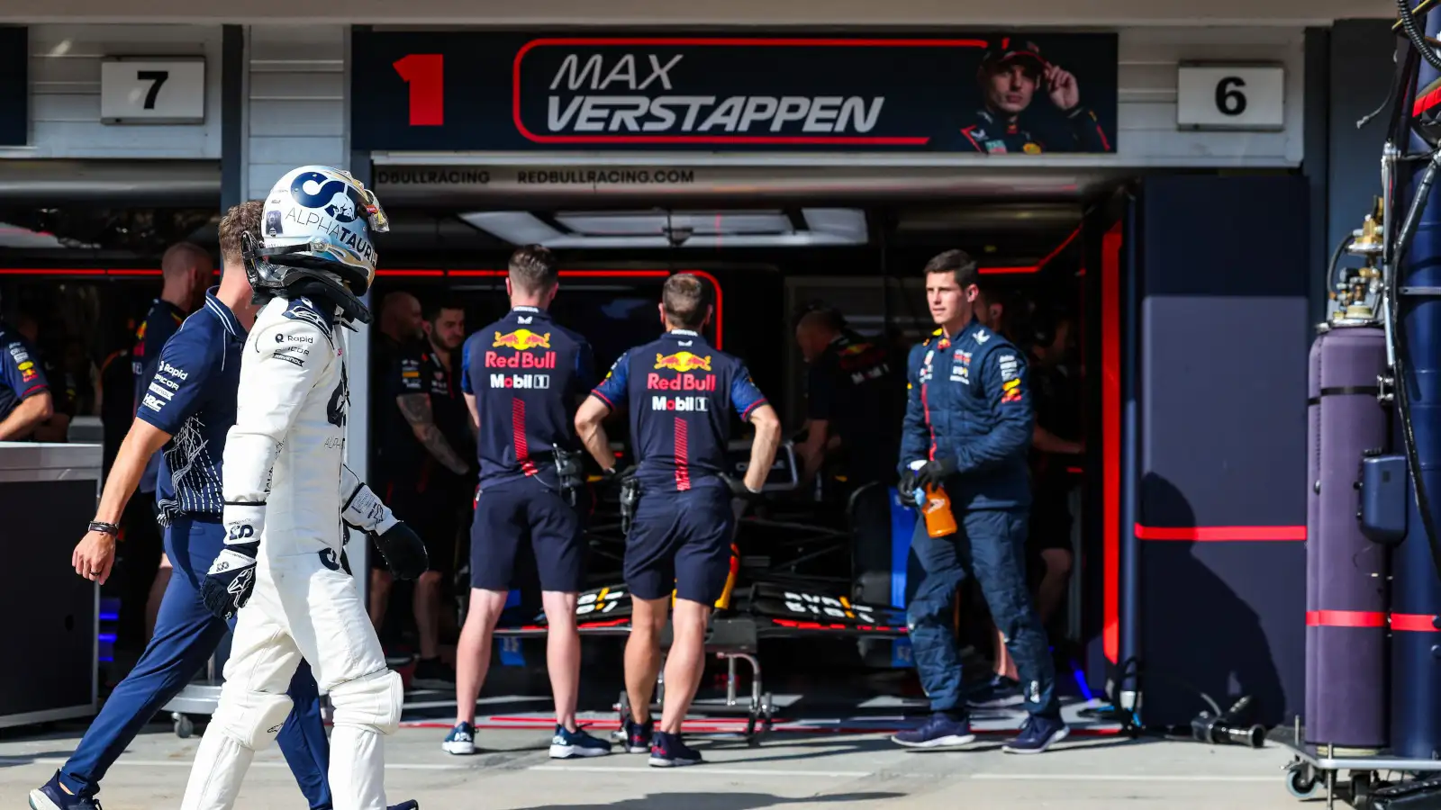 Daniel Ricciardo looking at Max Verstappen's Red Bull garage. Hungary July 2023