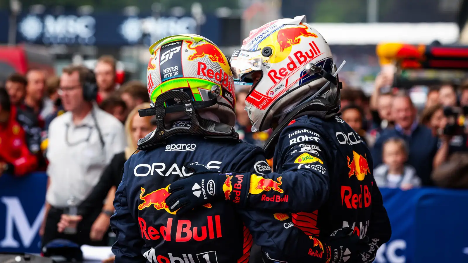 Sergio Perez and Max Verstappen hug after a 1-2 result. Belgium July 2023