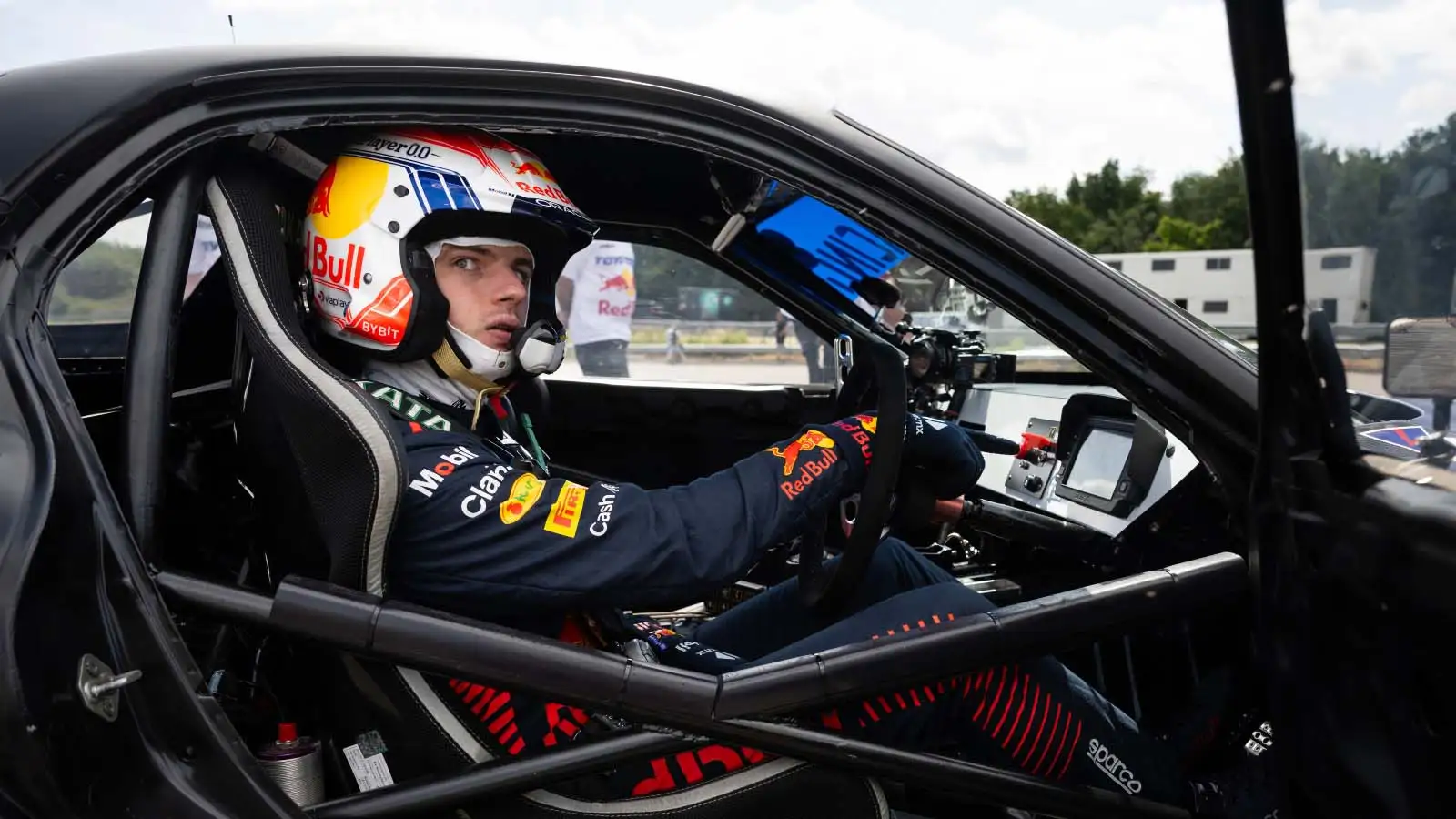Max Verstappen sits in the cockpit of a drift car.