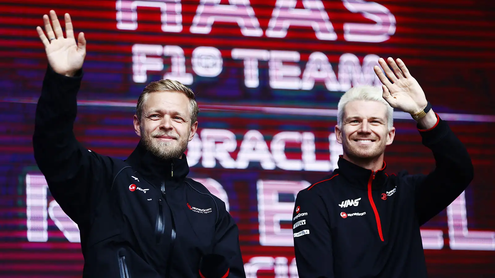 Kevin Magnussen and Nico Hulkenberg wave to the fans at the Belgian Grand Prix.