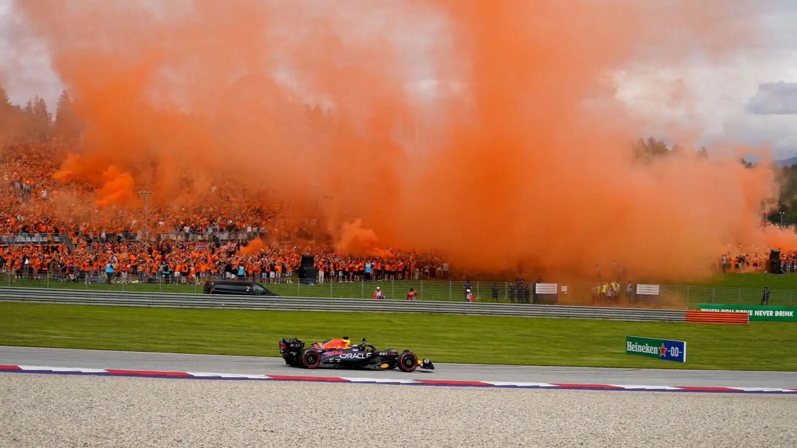 Max Verstappen drives past a stand full of fans. Dutch Grand Prix