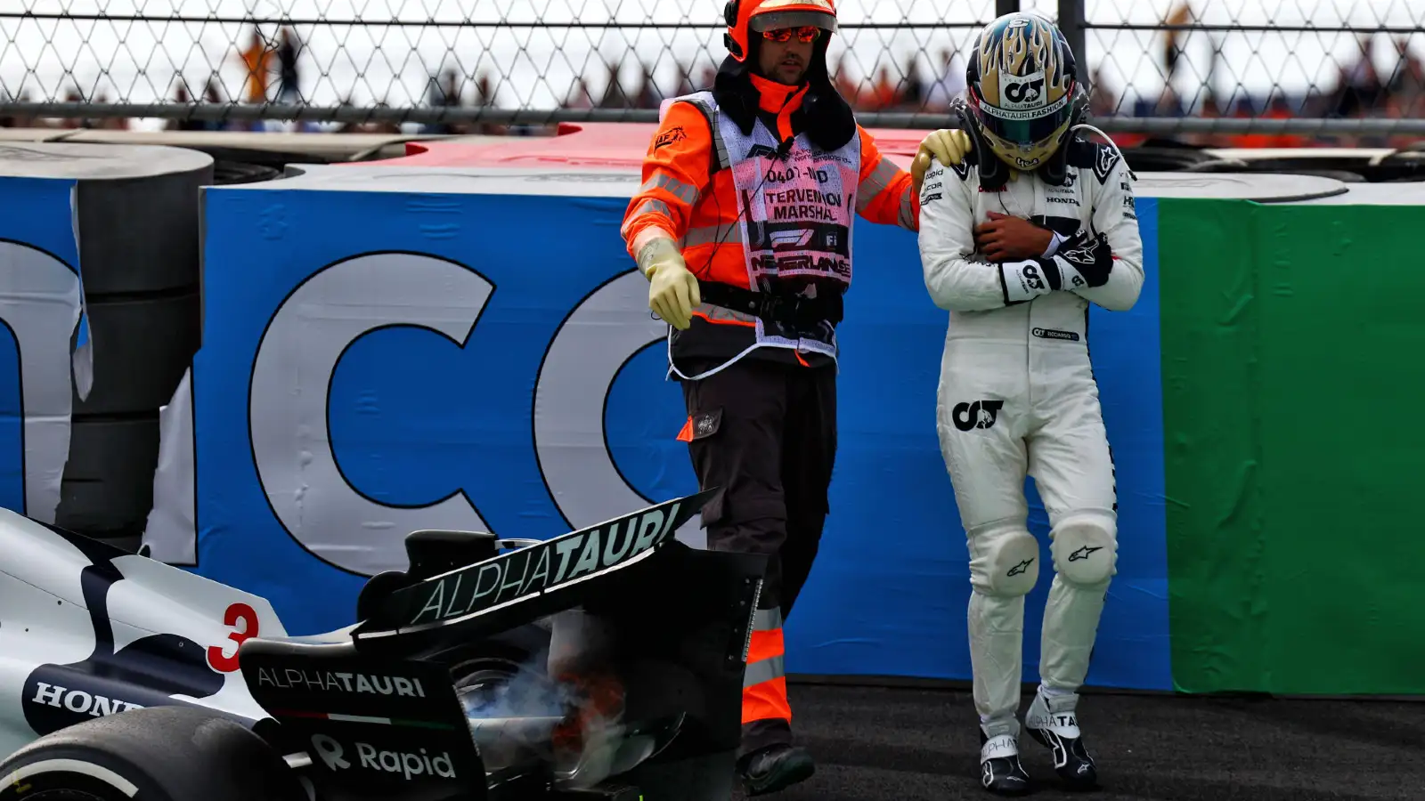Dutch Grand Prix: AlphaTauri's Daniel Ricciardo cradles his left hand in pain after crashing during FP2.