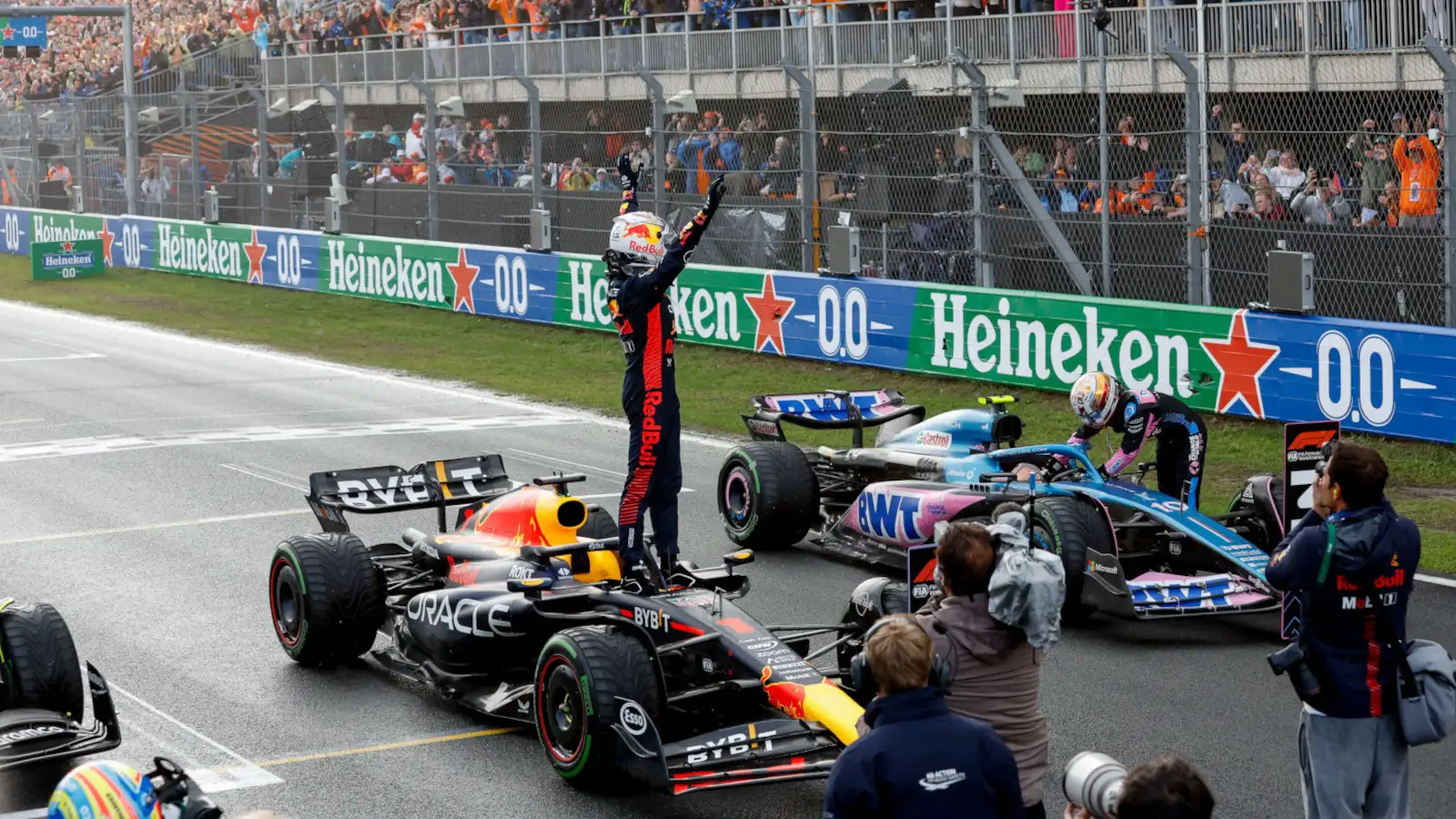 Max Verstappen standing on his Red Bull RB19 to celebrate his Dutch GP win.