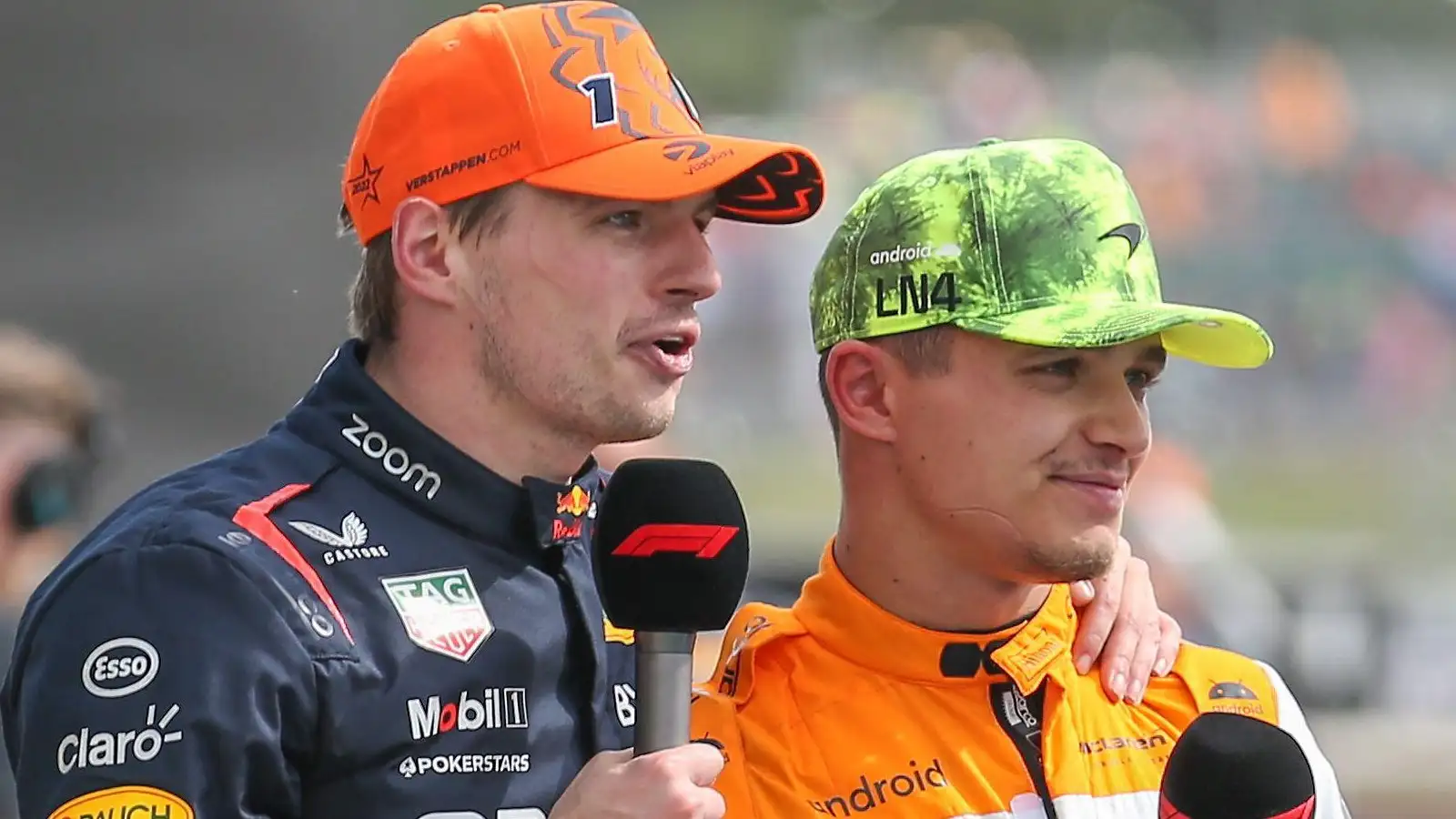 Max Verstappen places his hand on Lando Norris' shoulder during an F1 interview.