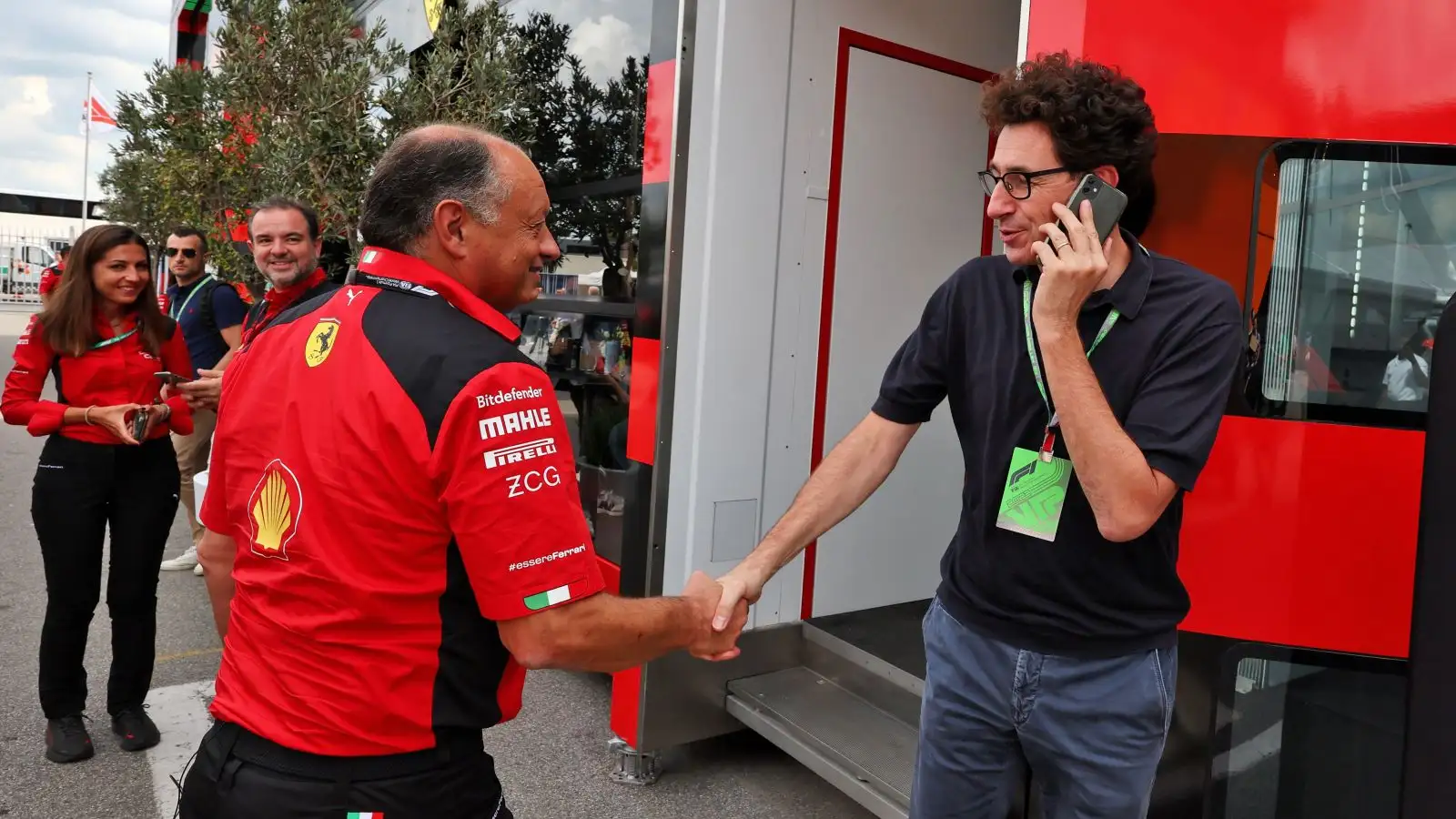 Ferrari team principal Fred Vasseur shakes the hand of his predecessor Mattia Binotto in the Monza F1 paddock.