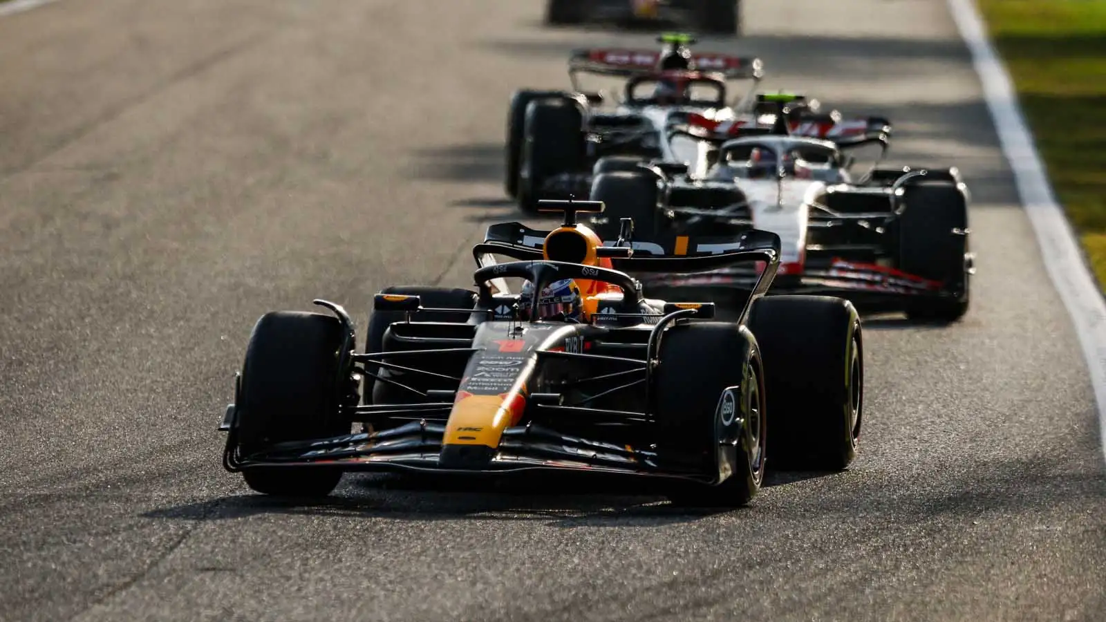 Max Verstappen leads a train of F1 cars at Monza.
