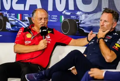 Ferrari team boss Fred Vasseur explains during a press conference while Christian Horner ponders.