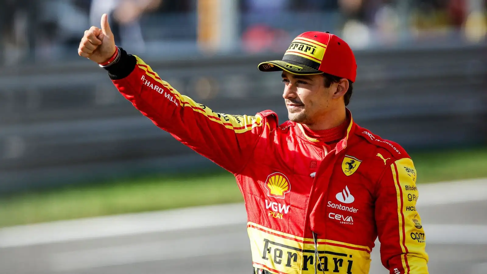 Ferrari driver Charles Leclerc waves to the crowd after qualifying third for the Italian Grand Prix at Monza.