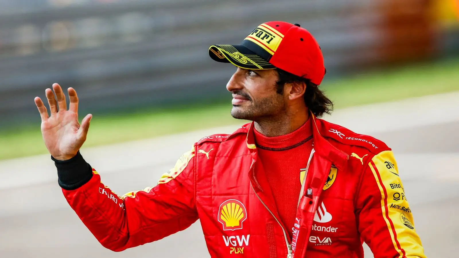 Ferrari driver Carlos Sainz waves to the crowd after setting pole position for the Italian Grand Prix at Monza.