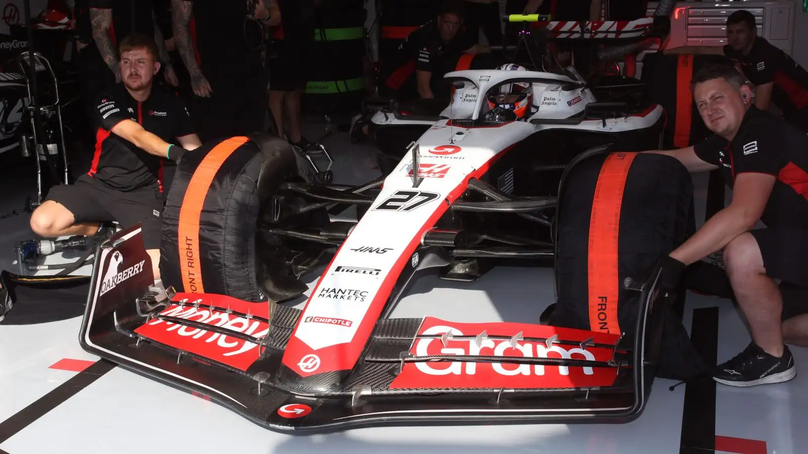 Haas driver Nico Hulkenberg with the tyre warmers on his VF-23 as he waits to leave the garage.
