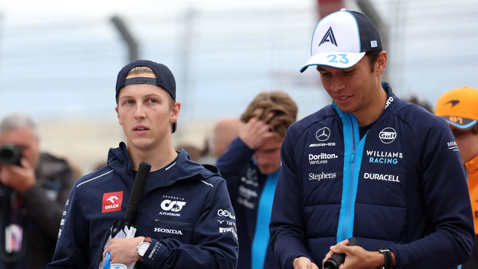 AlphaTauri diver Liam Lawson walking with Alex Albon