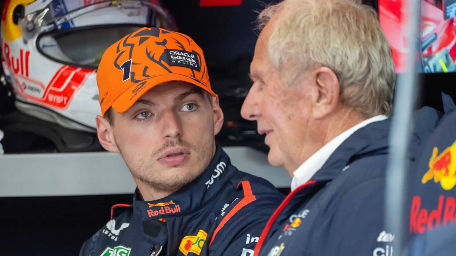 Max Verstappen in conversation with Helmut Marko in the Red Bull garage at the 2023 Belgian Grand Prix.