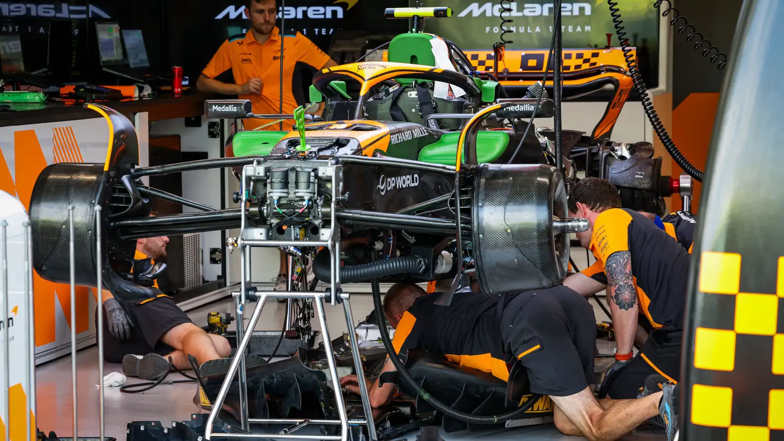 McLaren mechanics working on the car in the team's garage ahead of the Singapore GP.