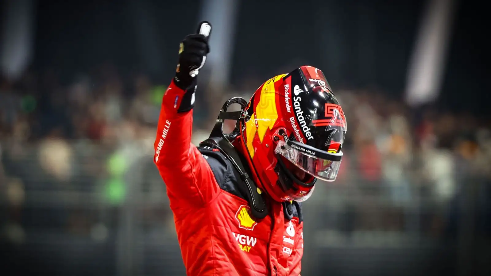 Ferrari driver Carlos Sainz celebrates after setting pole position for the 2023 Singapore Grand Prix.