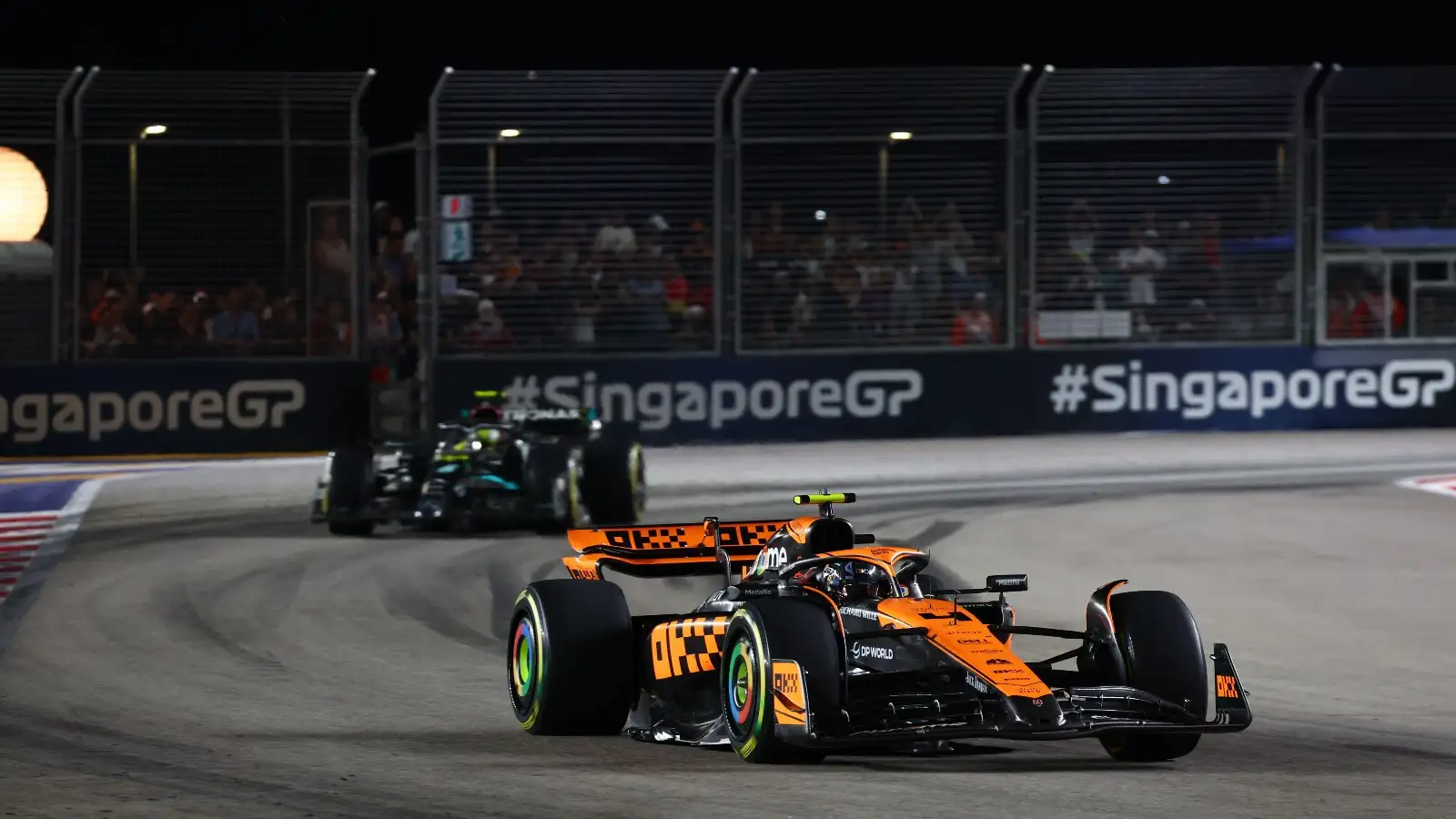 Lando Norris rounds the corner ahead of Lewis Hamilton.