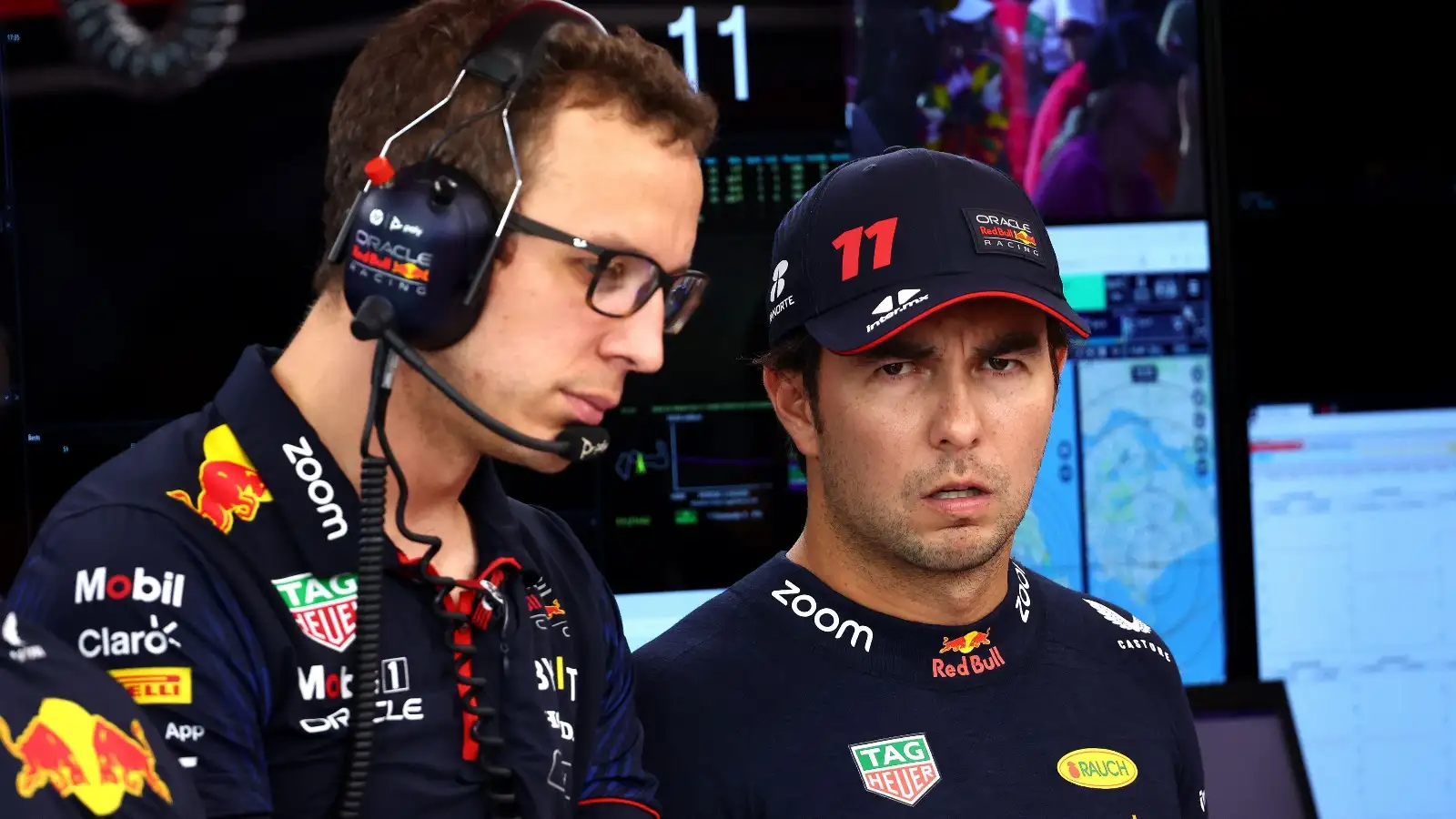 Sergio Perez talks in Red Bull garage.
