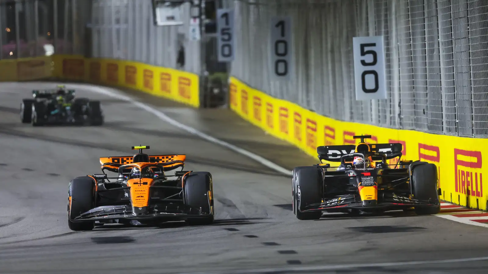 Red Bull's Max Verstappen battling with McLaren's Lando Norris at the Singapore Grand Prix.
