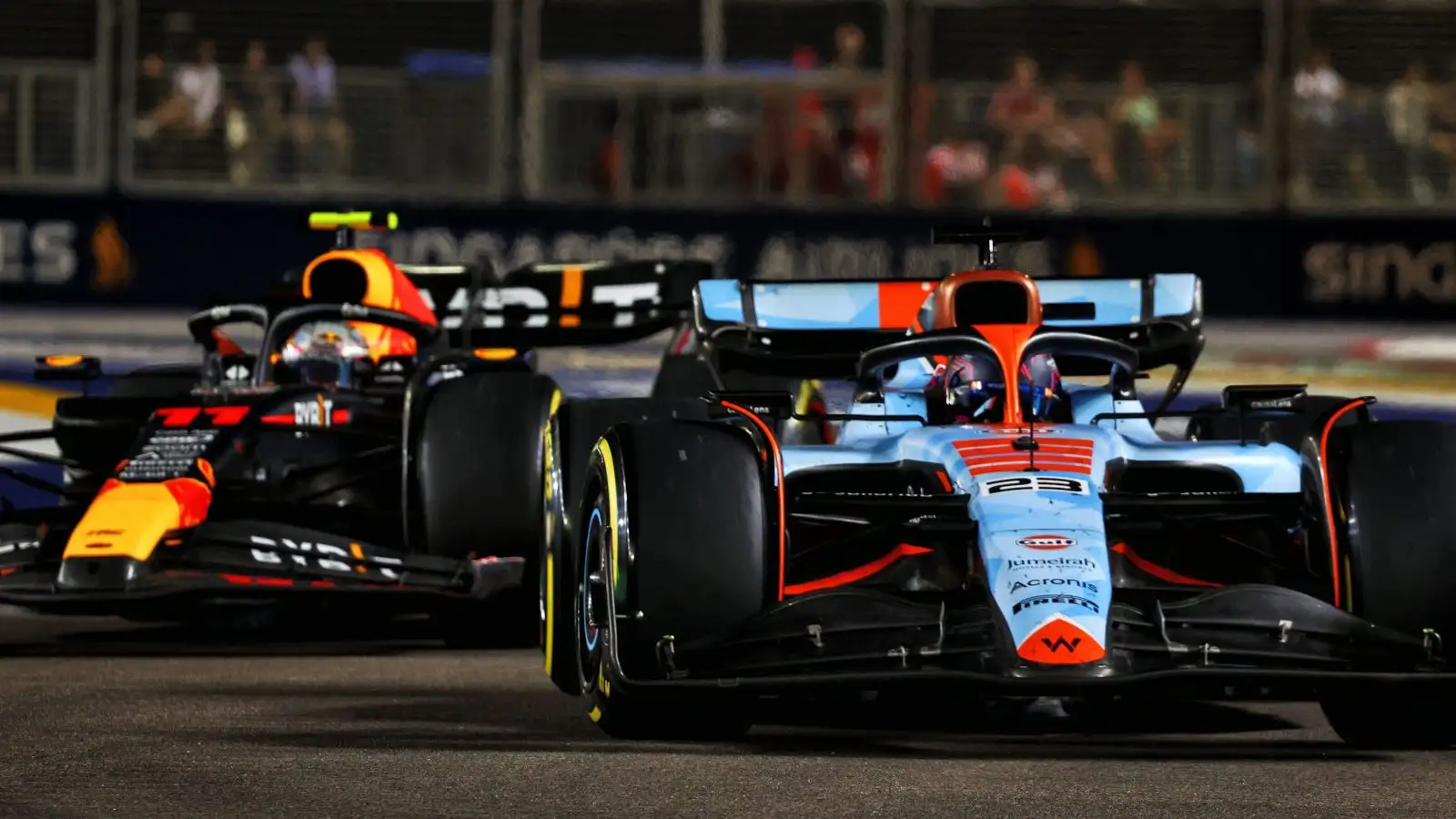 Red Bull driver Sergio Perez all over the rear of Alex Albon's Williams.