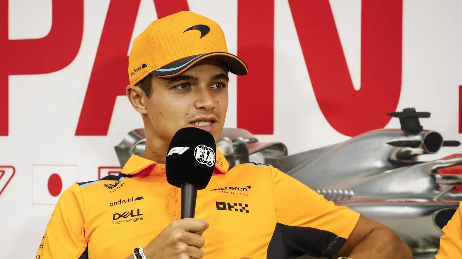 McLaren driver Lando Norris with the mic on the couch in the driver press conference.