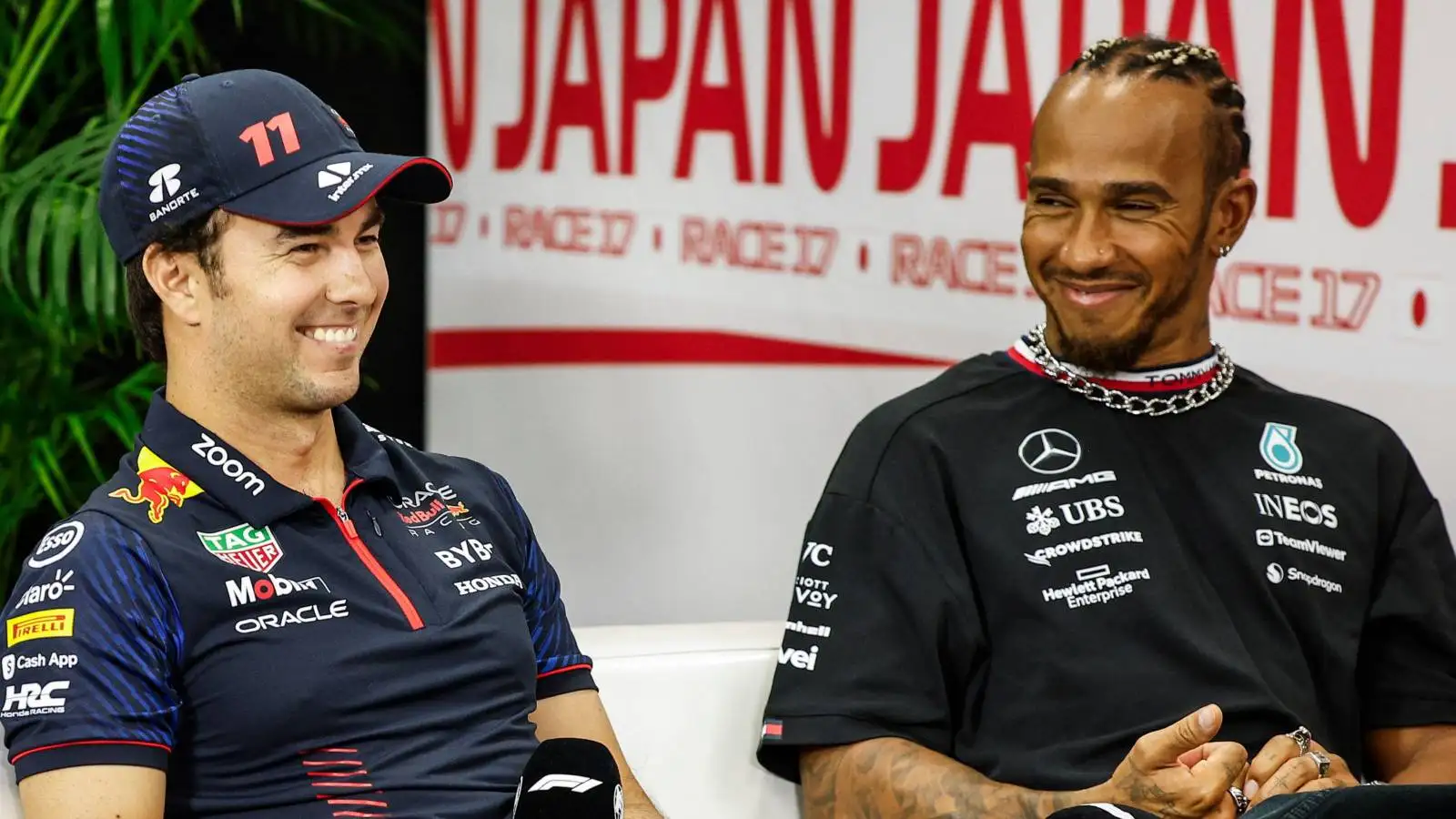 Sergio Perez, Red Bull and Lewis Hamilton, Mercedes, smiling. Japan, September 2023.