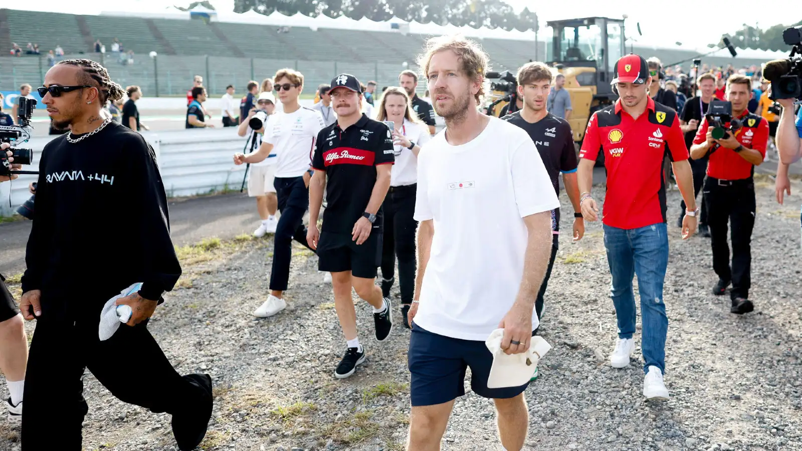 Mercedes' Lewis Hamilton pictured with four-time World Champion Sebastian Vettel at Suzuka.