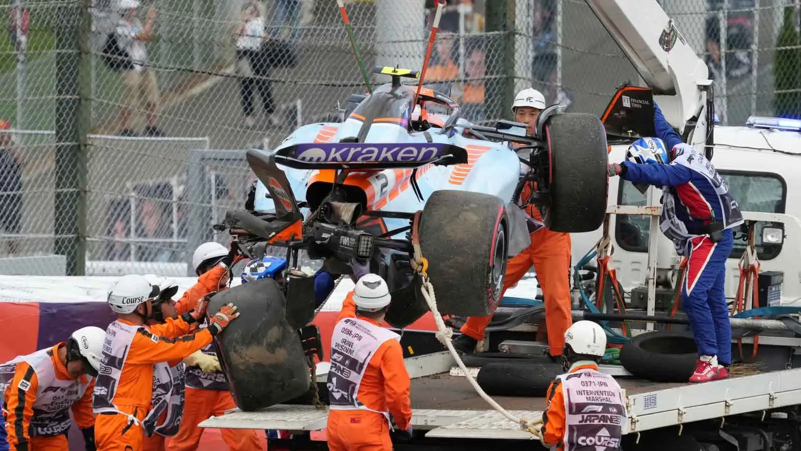 Logan Sargeant is lifted onto a truck.