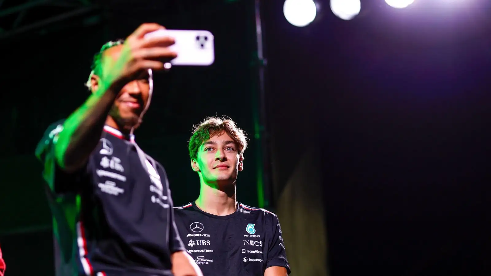 Mercedes drivers Lewis Hamilton and George Russell pose for a selfie at the 2023 Japanese Grand Prix.