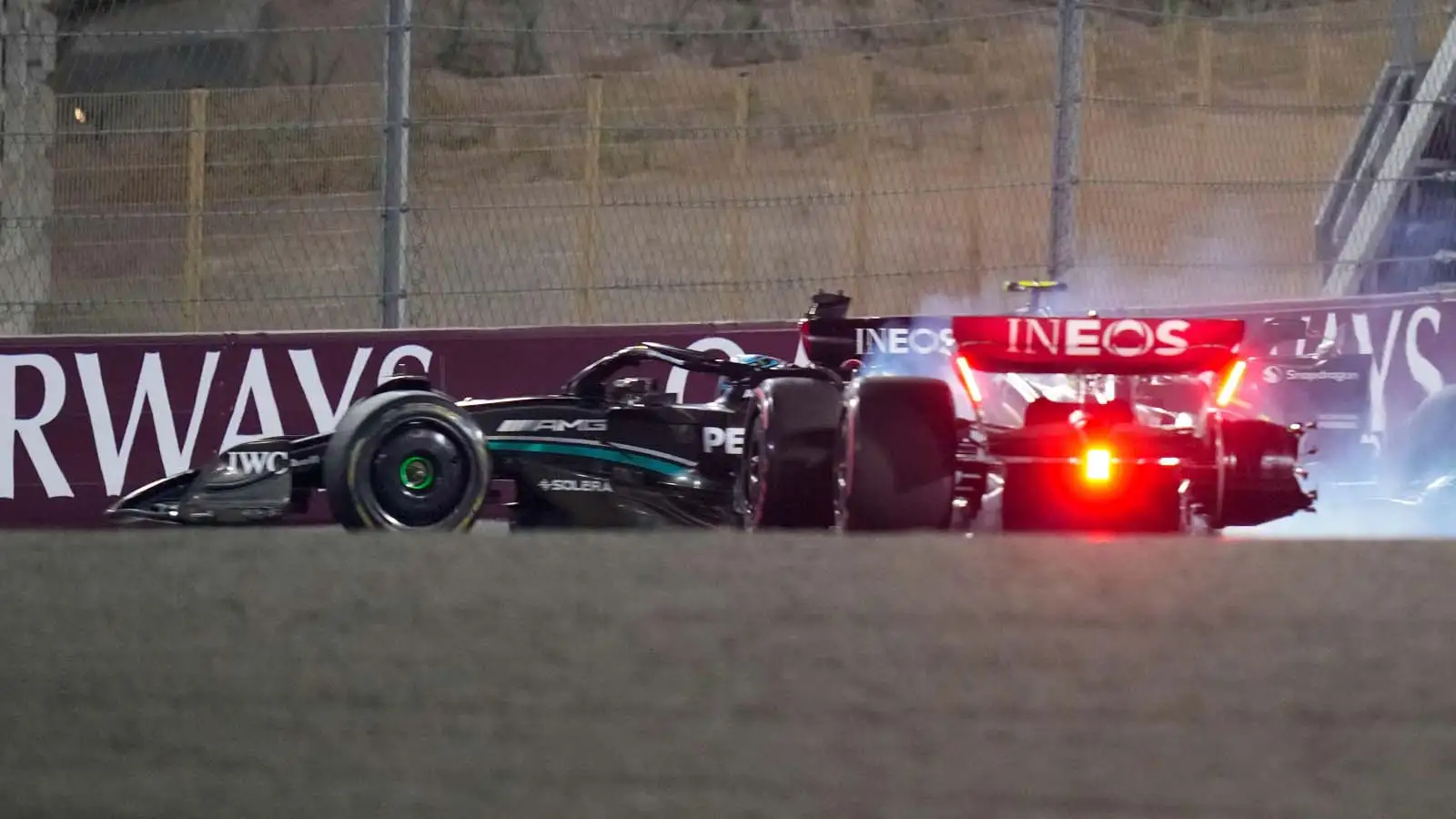 Lewis Hamilton slides off after colliding with George Russell.