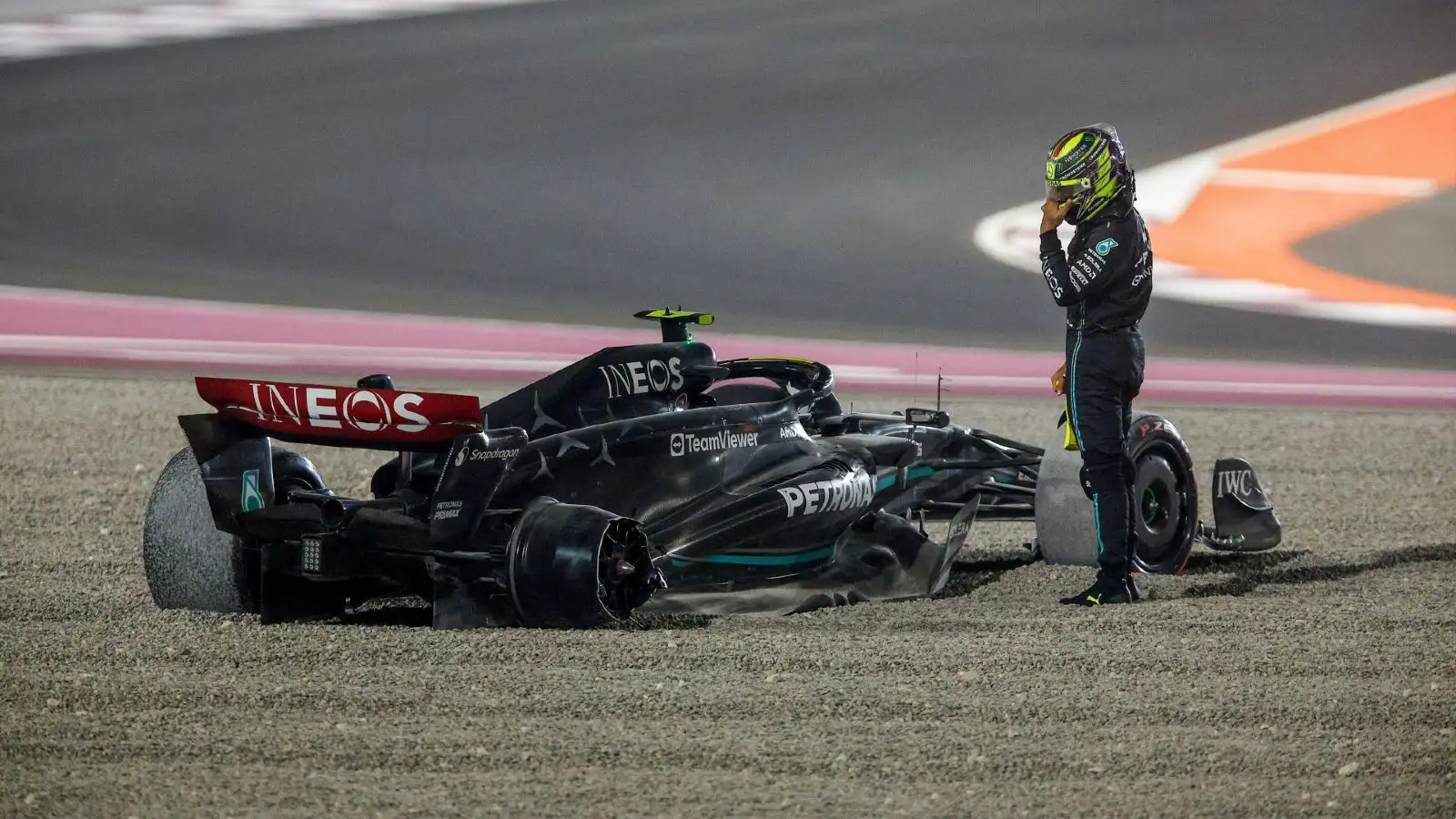 Mercedes' Lewis Hamilton looks on at his crashed Q14 during the Qatar Grand Prix.