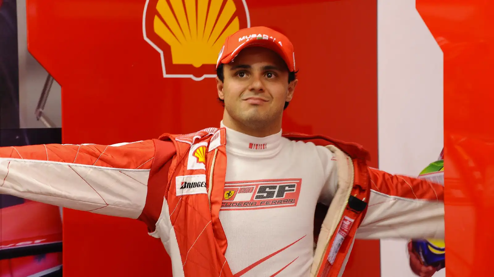 Ferrari's Felipe Massa pulls on his overalls at the 2008 Brazilian Grand Prix.
