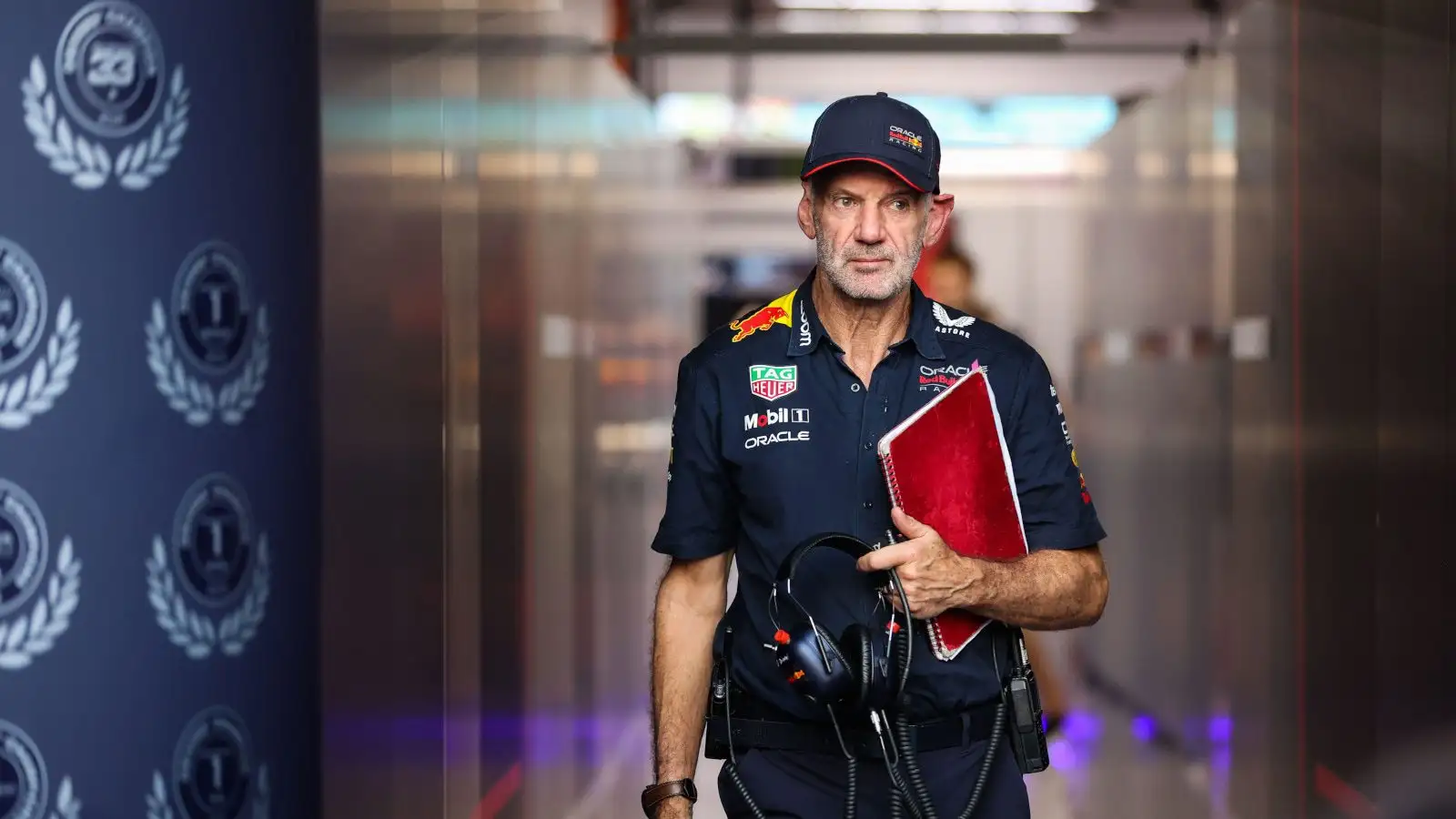 Red Bull design guru Adrian Newey walking down the tunnel with Red Bull accolades on the wall.