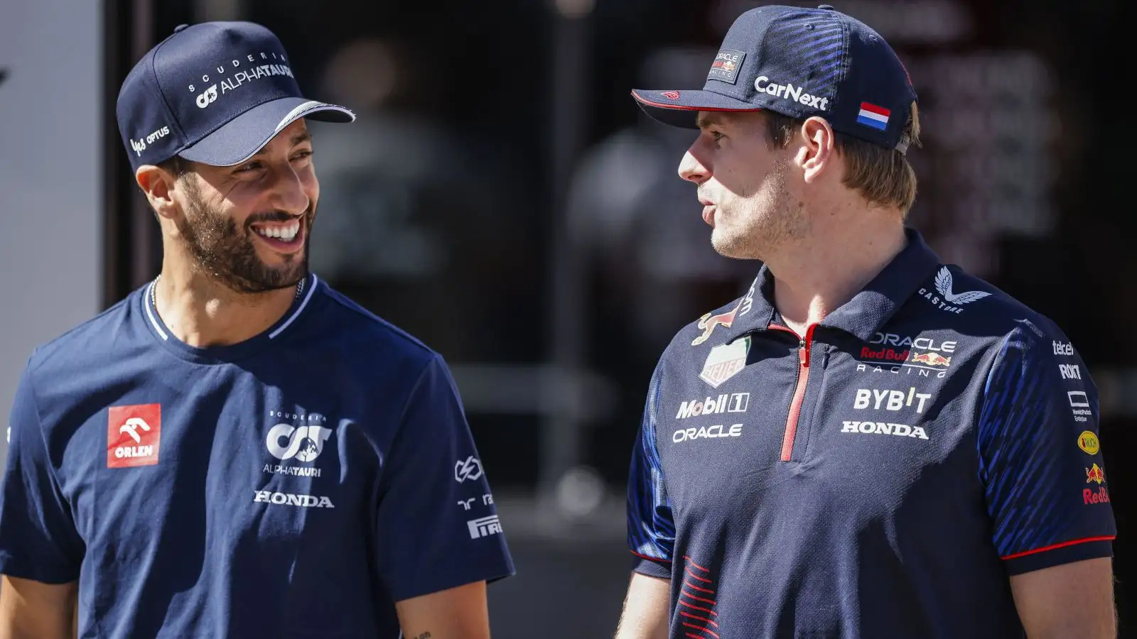 Red Bull hopeful Daniel Ricciardo talking to Max Verstappen.
