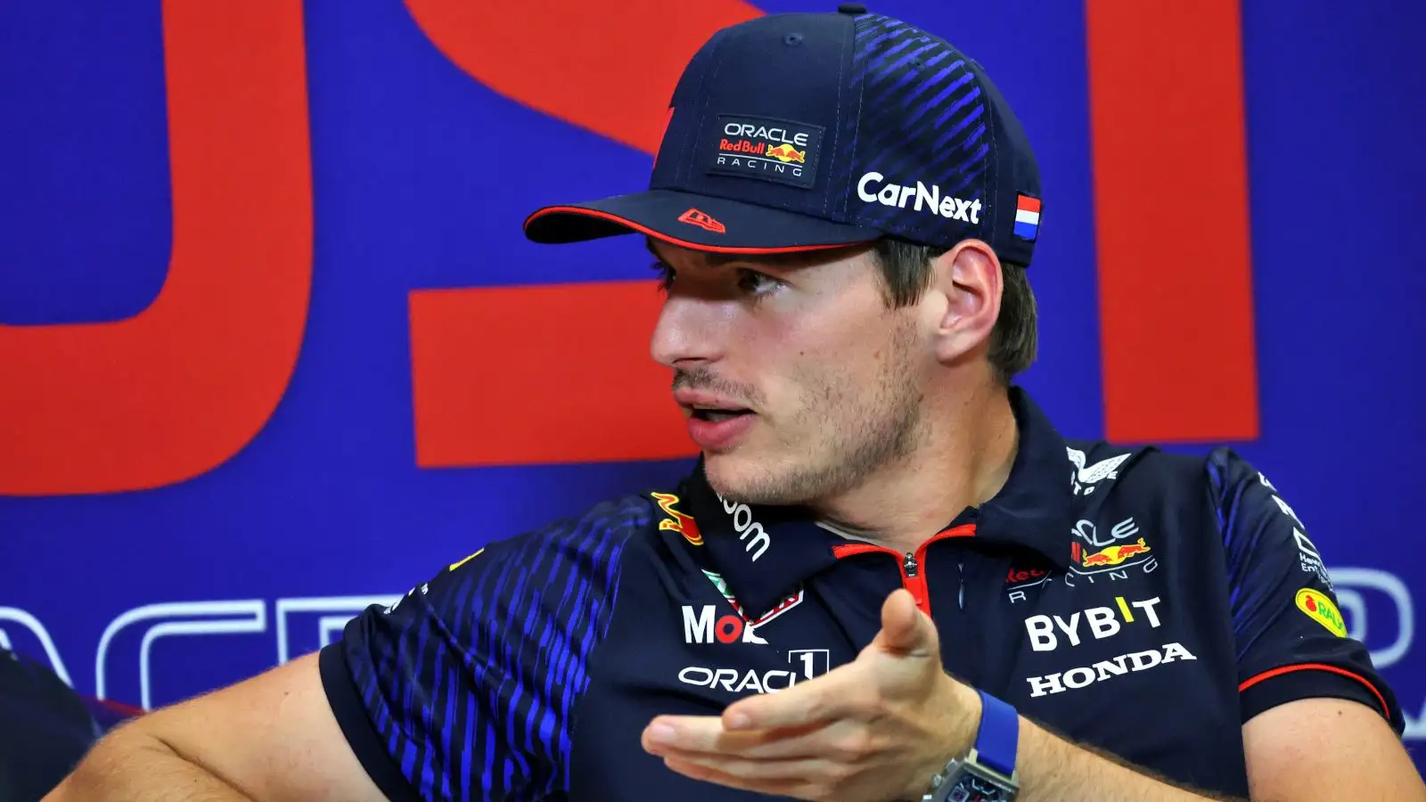 Red Bull driver Max Verstappen gesturing in the press conference.