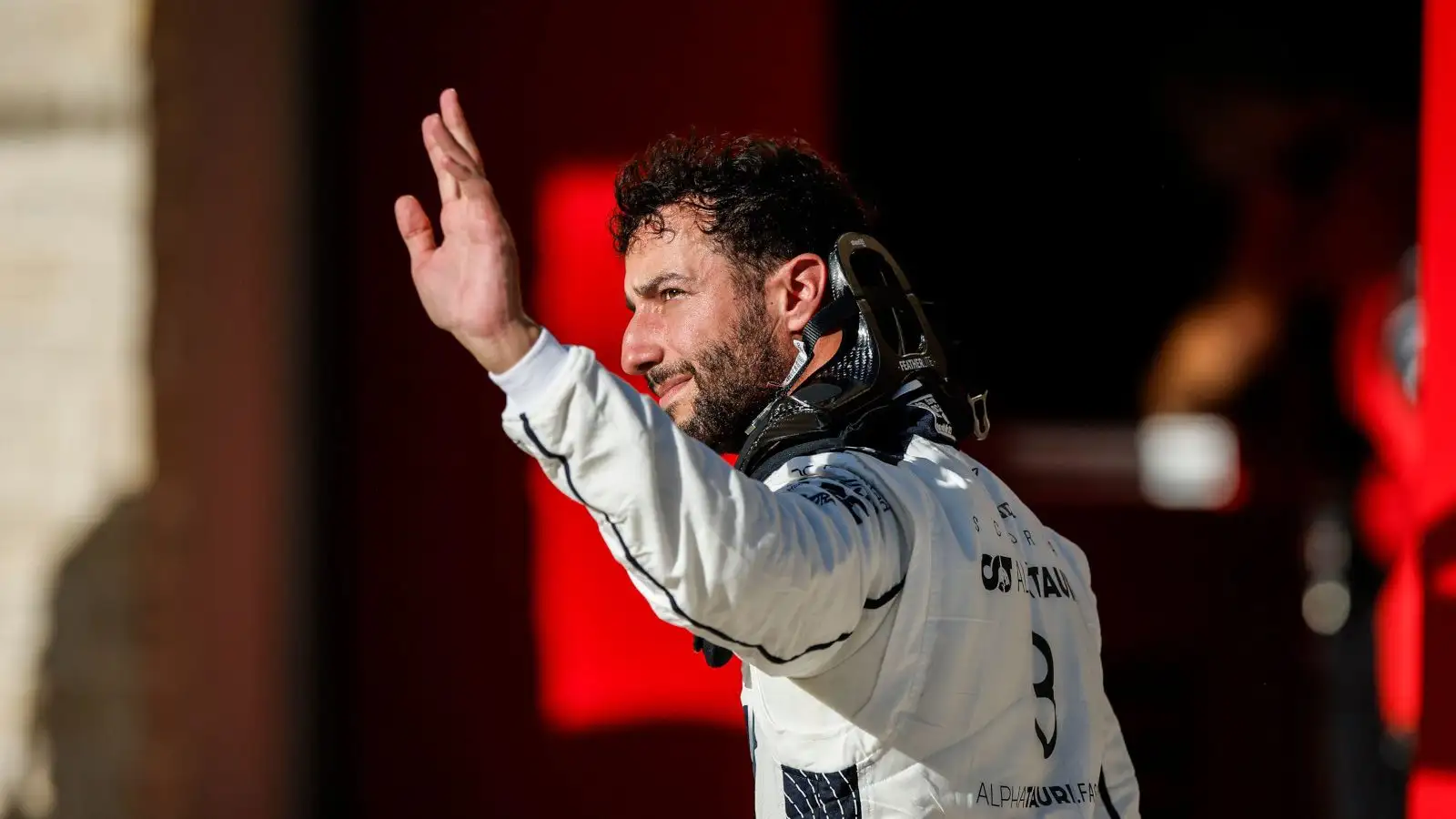 AlphaTauri driver Daniel Ricciardo waves to the fans after qualifying.
