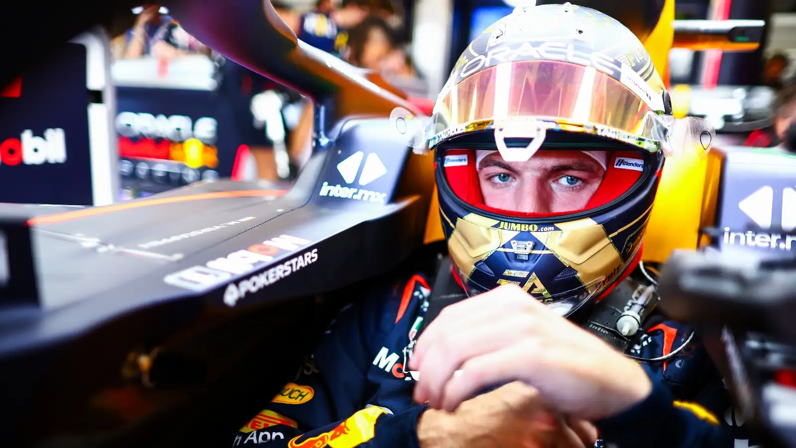 Max Verstappen sitting in the cockpit of the Red Bull RB19.