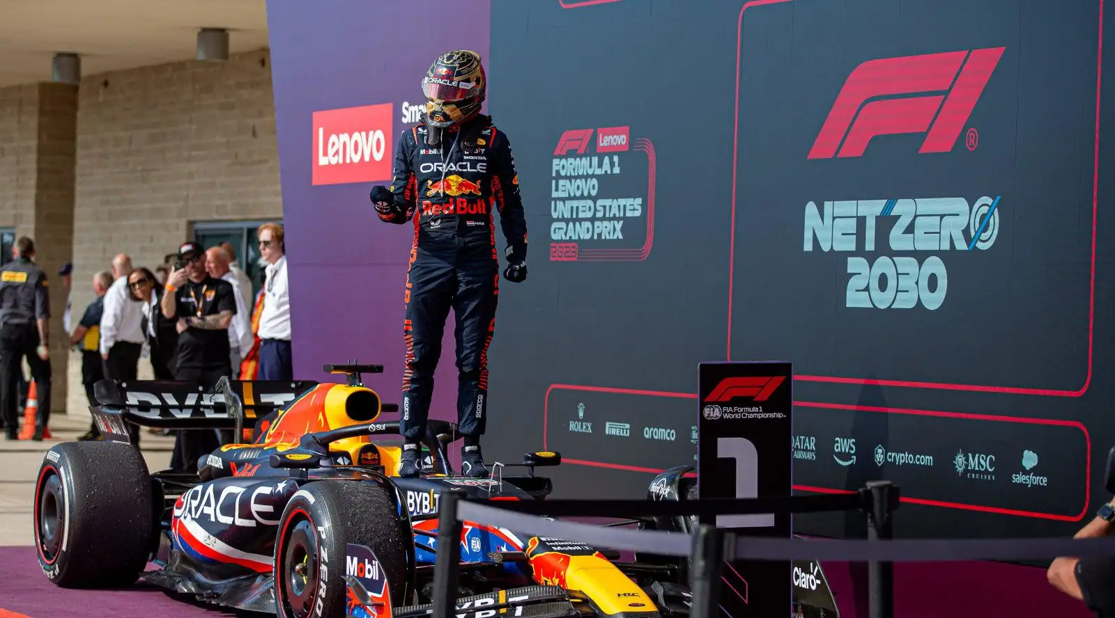 Red Bull driver Max Verstappen stands on his RB19 to celebrate after winning the United States GP.