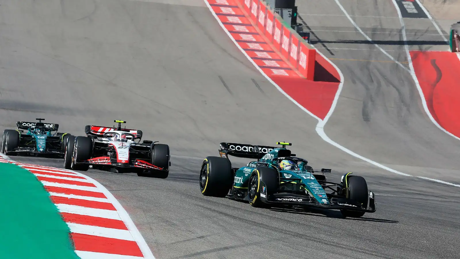 Fernando Alonso holds off a Haas during the 2023 United States Grand Prix.