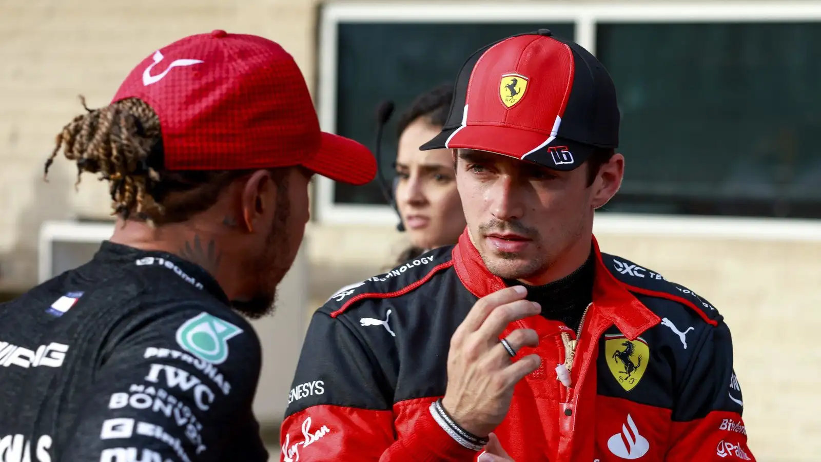 Ferrari driver Charles Leclerc chatting with Lewis Hamilton.