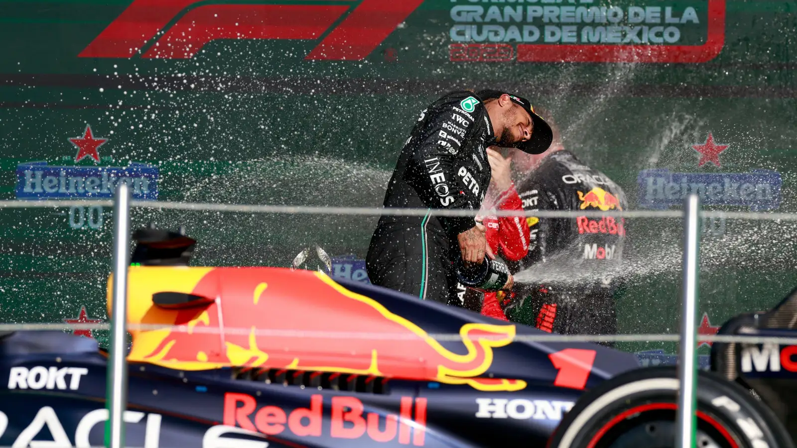 Mercedes driver Lewis Hamilton on the podium with Max Verstappen and the RB19.