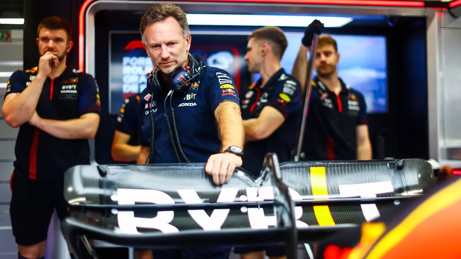 Christian Horner touches the Red Bull RB19 rear wing.