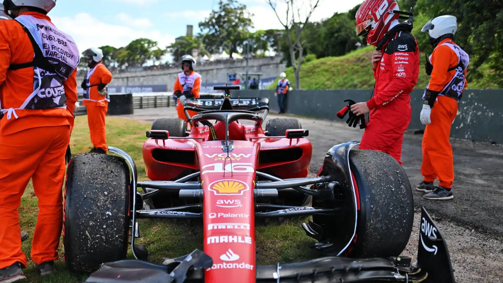 Charles Leclerc stood with his Ferrari after crashing on the Brazil formation lap.