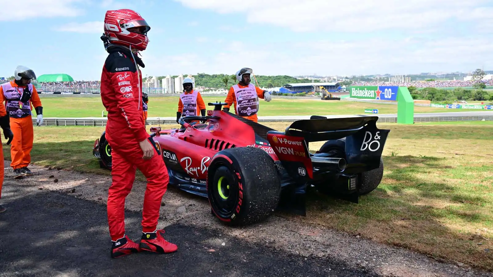 Charles Leclerc walks clear of his stricken Ferrari.